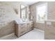 Stylish powder room with floral wallpaper, marble counters, and decorative mirror at 295 Jersey St, Denver, CO 80220