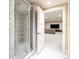 Tiled shower with a glass door, complemented by a view of the finished basement, creating a seamless transition at 295 Jersey St, Denver, CO 80220