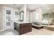 Elegant bathroom with a modern fireplace separating the bath area from the bedroom at 295 Jersey St, Denver, CO 80220