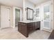 Elegant bathroom with custom vanity, marble countertop, and stylish herringbone flooring at 295 Jersey St, Denver, CO 80220
