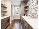 Charming butler's pantry offers ample storage space, a wine fridge, and a stylish backsplash at 295 Jersey St, Denver, CO 80220