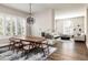 Open dining area with hardwood floors, modern chandelier, and fireplace at 295 Jersey St, Denver, CO 80220
