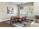 Dining room featuring hardwood floors, modern chandelier, and fireplace view at 295 Jersey St, Denver, CO 80220