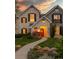 Charming two-story home with stone facade, black shutters, and landscaped front yard at 295 Jersey St, Denver, CO 80220