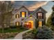 Charming two-story home with stone facade, black shutters, and landscaped front yard at 295 Jersey St, Denver, CO 80220