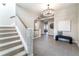 Open foyer with hardwood floors, staircase, and elegant chandelier at 295 Jersey St, Denver, CO 80220