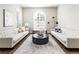 Bright living room with white sofas, round coffee table, and large window at 295 Jersey St, Denver, CO 80220