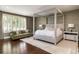 Serene bedroom with four-poster bed, hardwood floors, and abundant natural light at 295 Jersey St, Denver, CO 80220