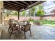 Covered patio with a dining set, built-in grill, stone fireplace, and a cozy outdoor entertaining area at 295 Jersey St, Denver, CO 80220