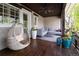 Relaxing porch features comfortable seating, a hanging chair, and charming flower pots at 295 Jersey St, Denver, CO 80220