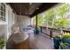 Charming covered porch with a hanging chair, providing an inviting outdoor seating area at 295 Jersey St, Denver, CO 80220