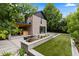 Inviting backyard featuring a jacuzzi, dining area, and lush landscaping, providing a serene retreat for homeowners at 9161 W Lake Dr, Littleton, CO 80123
