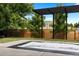 Private backyard featuring a sunken jacuzzi, framed pergola, and well-maintained lawn for relaxation and entertainment at 9161 W Lake Dr, Littleton, CO 80123