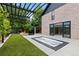 Spacious backyard featuring in-ground jacuzzi, outdoor kitchen, dining area, and sliding glass doors into the home at 9161 W Lake Dr, Littleton, CO 80123