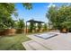 Backyard with in-ground jacuzzi, pergola, manicured lawn, and a brick planter box, ideal for outdoor living at 9161 W Lake Dr, Littleton, CO 80123