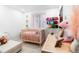 Charming Bedroom with pink crib, soft lighting, and colorful wall decorations, perfect for a baby girl at 9161 W Lake Dr, Littleton, CO 80123