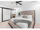 Primary bedroom includes a large bed, private window and slider to bath area at 9161 W Lake Dr, Littleton, CO 80123