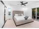 Spacious primary bedroom features large windows, a ceiling fan, and a comfortable bed at 9161 W Lake Dr, Littleton, CO 80123