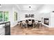 Dining room with fireplace, modern light fixture, wood floors, and ample space at 9161 W Lake Dr, Littleton, CO 80123