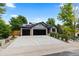 Inviting home boasting a three-car garage, modern design elements, and drought-resistant landscaping at 9161 W Lake Dr, Littleton, CO 80123