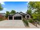 Charming single-story home featuring a three-car garage and well-manicured landscaping at 9161 W Lake Dr, Littleton, CO 80123