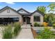 Charming front exterior of a home featuring a brick facade, well-manicured landscaping, and inviting entryway at 9161 W Lake Dr, Littleton, CO 80123