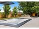Backyard hot tub with brick feature, privacy fence, pergola, and exterior building at 9161 W Lake Dr, Littleton, CO 80123