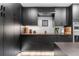 Sleek kitchen design with dark cabinetry and integrated stainless steel appliances at 9161 W Lake Dr, Littleton, CO 80123