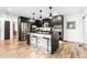 Stylish kitchen with an island, bar stools, and stainless steel appliances at 9161 W Lake Dr, Littleton, CO 80123