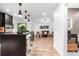 Open-concept kitchen and dining area with a large island, pendant lights, and seamless access to a dining room at 9161 W Lake Dr, Littleton, CO 80123