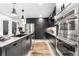 Modern kitchen showcasing stainless steel appliances and sleek black cabinetry at 9161 W Lake Dr, Littleton, CO 80123
