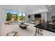 Bright living room with large sliding glass doors, bar seating, and a stylish modern aesthetic with backyard pool access at 9161 W Lake Dr, Littleton, CO 80123