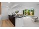 Living space including a sleek black kitchen island and a view of the pool at 9161 W Lake Dr, Littleton, CO 80123