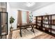 Stylish office with a wooden desk, shelving, decorative rug, and ample natural light from curtained windows at 9161 W Lake Dr, Littleton, CO 80123
