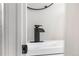 Modern bathroom featuring a black faucet and a white single sink vanity at 4625 Webster St, Wheat Ridge, CO 80033
