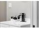 Modern bathroom featuring a black faucet and white towels tied with ribbon at 4625 Webster St, Wheat Ridge, CO 80033