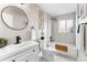 Bathroom with a modern sink, mirror, bathtub and gold decor accents at 4625 Webster St, Wheat Ridge, CO 80033