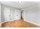 Bedroom featuring hardwood floors, neutral paint, storage, and access to other areas at 4625 Webster St, Wheat Ridge, CO 80033