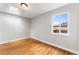 Bedroom featuring wood floors, neutral paint, natural light, and a skylight at 4625 Webster St, Wheat Ridge, CO 80033