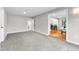 Open bonus room or living space with soft carpet, grey walls and a view of the dining area at 4625 Webster St, Wheat Ridge, CO 80033