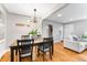 Dining area features a wooden table with a plant centerpiece, light fixture, and hardwood floors at 4625 Webster St, Wheat Ridge, CO 80033