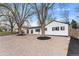 Charming single-story home featuring a low-maintenance, xeriscaped front yard, fresh white paint, and a driveway leading to an attached garage at 4625 Webster St, Wheat Ridge, CO 80033