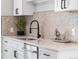 Kitchen featuring white countertops and cabinets, stainless steel sink and modern faucet at 4625 Webster St, Wheat Ridge, CO 80033