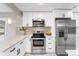 Kitchen with stainless steel appliances, updated countertops, and a stylish backsplash at 4625 Webster St, Wheat Ridge, CO 80033