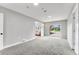 Bright living room features neutral paint, carpet, and sliding glass doors leading to the outdoors at 4625 Webster St, Wheat Ridge, CO 80033