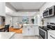 Open concept living and kitchen area with hardwood floors and modern cabinets and appliances at 4625 Webster St, Wheat Ridge, CO 80033