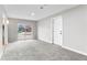 Bright living room with neutral paint, carpet, sliding glass doors, and white trim at 4625 Webster St, Wheat Ridge, CO 80033