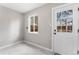 Mud room featuring white tile flooring, natural light, and white door leading to the backyard at 4625 Webster St, Wheat Ridge, CO 80033