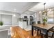Open concept layout of the kitchen, dining room, and living room area with light gray walls and hardwood floors at 4625 Webster St, Wheat Ridge, CO 80033