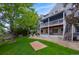 Well-maintained backyard with a cozy patio area, mature trees, lawn space, and access to the upper deck at 8927 Green Meadows Ln, Highlands Ranch, CO 80126